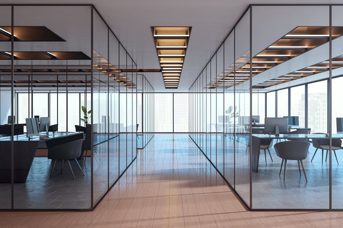 Contemporary empty office interior with glass partitions, stylish furniture and city view in background. Corporate workspace concept. 3D Rendering