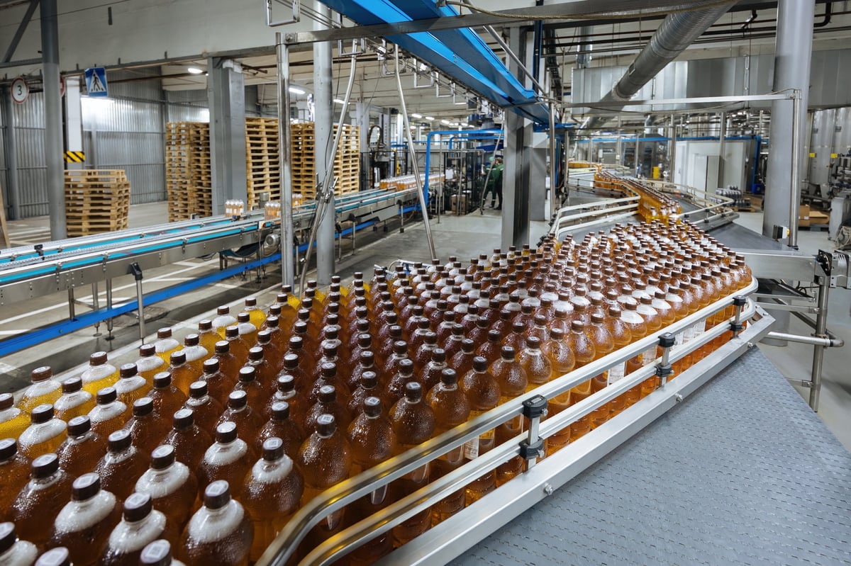 Production line of bottling of beverage into plastic bottles and packing.